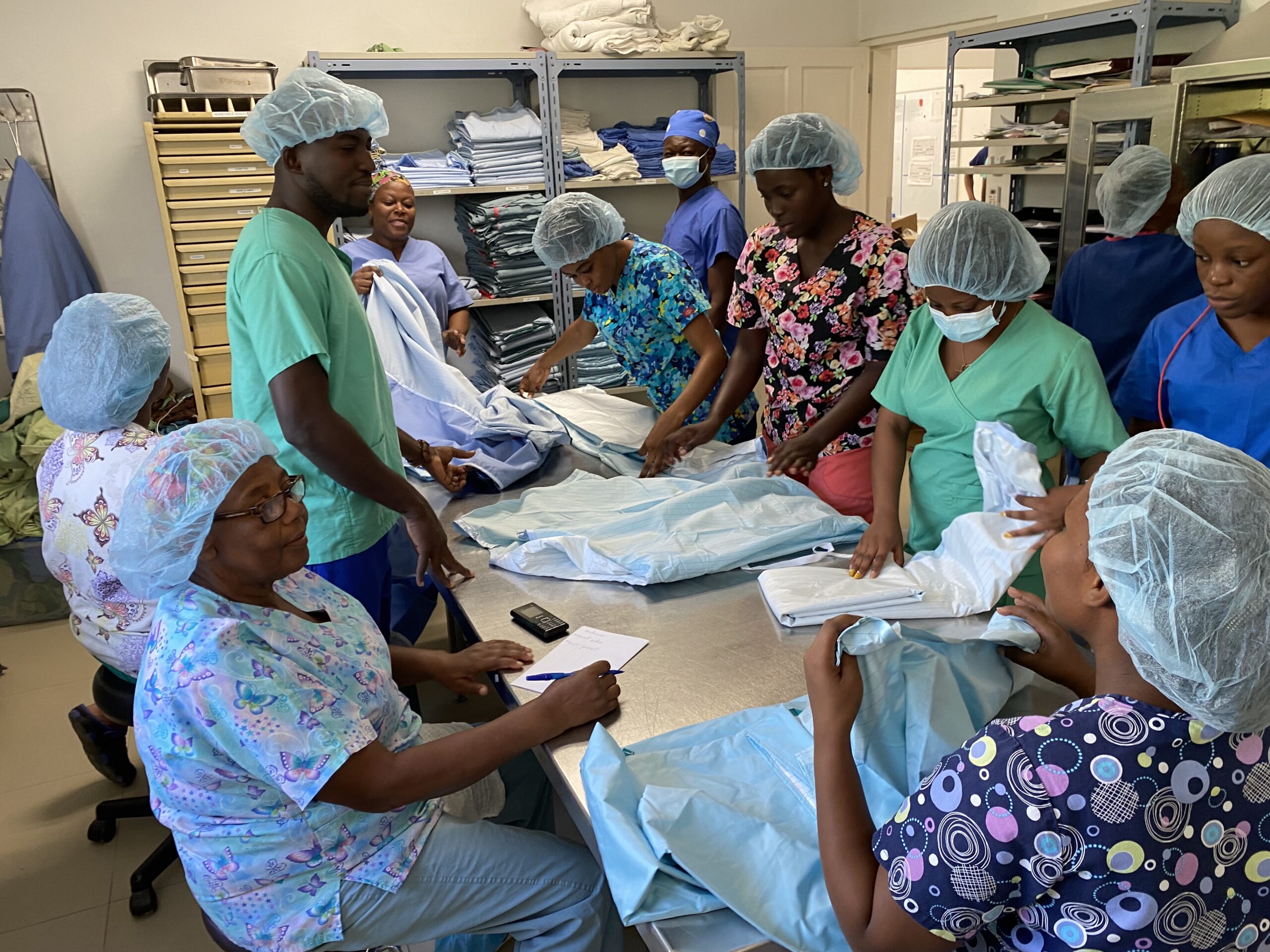 Nurses prepare our new reusable surgical gowns and drapes