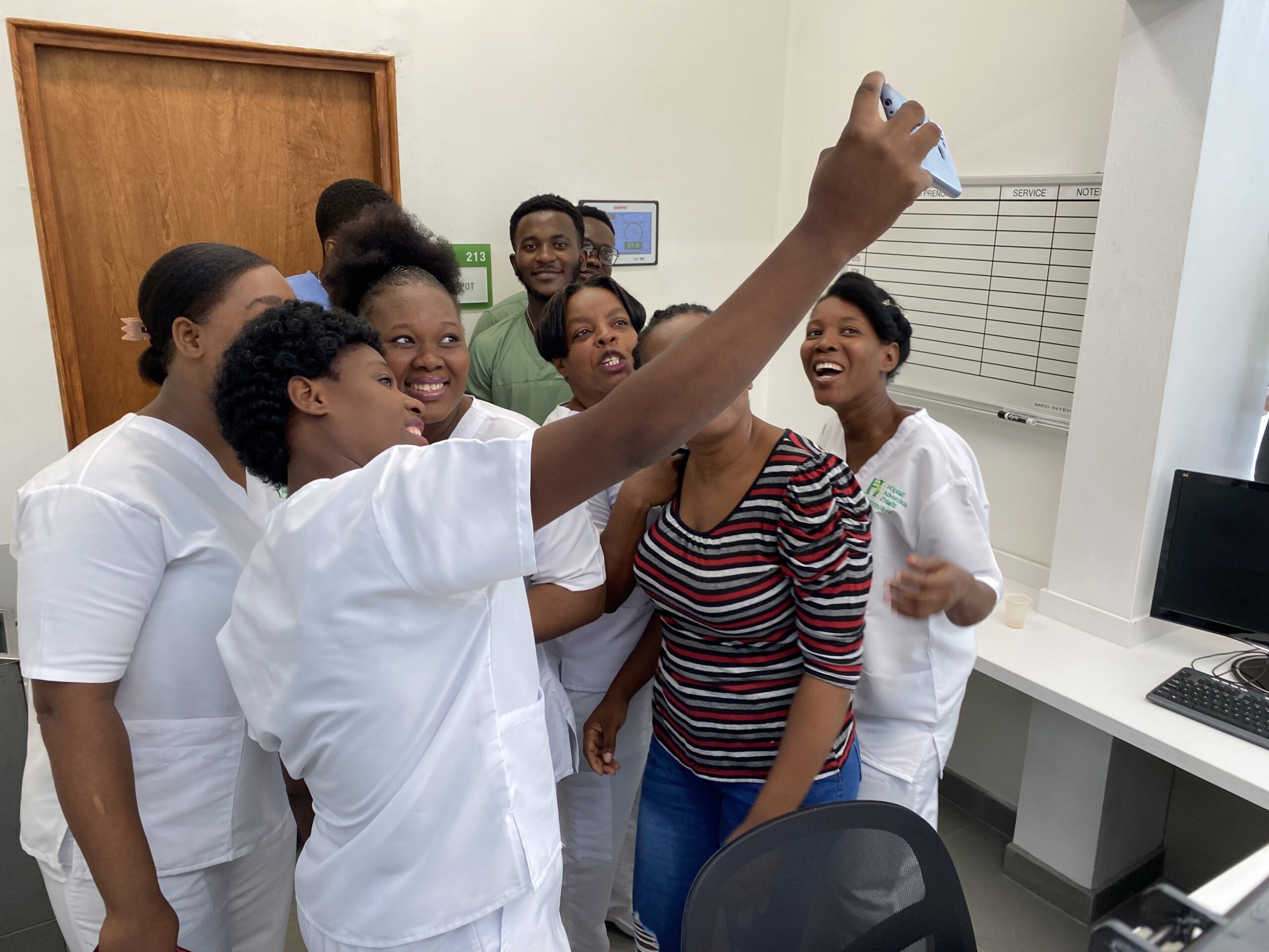 nurses take a selfie in a new office space