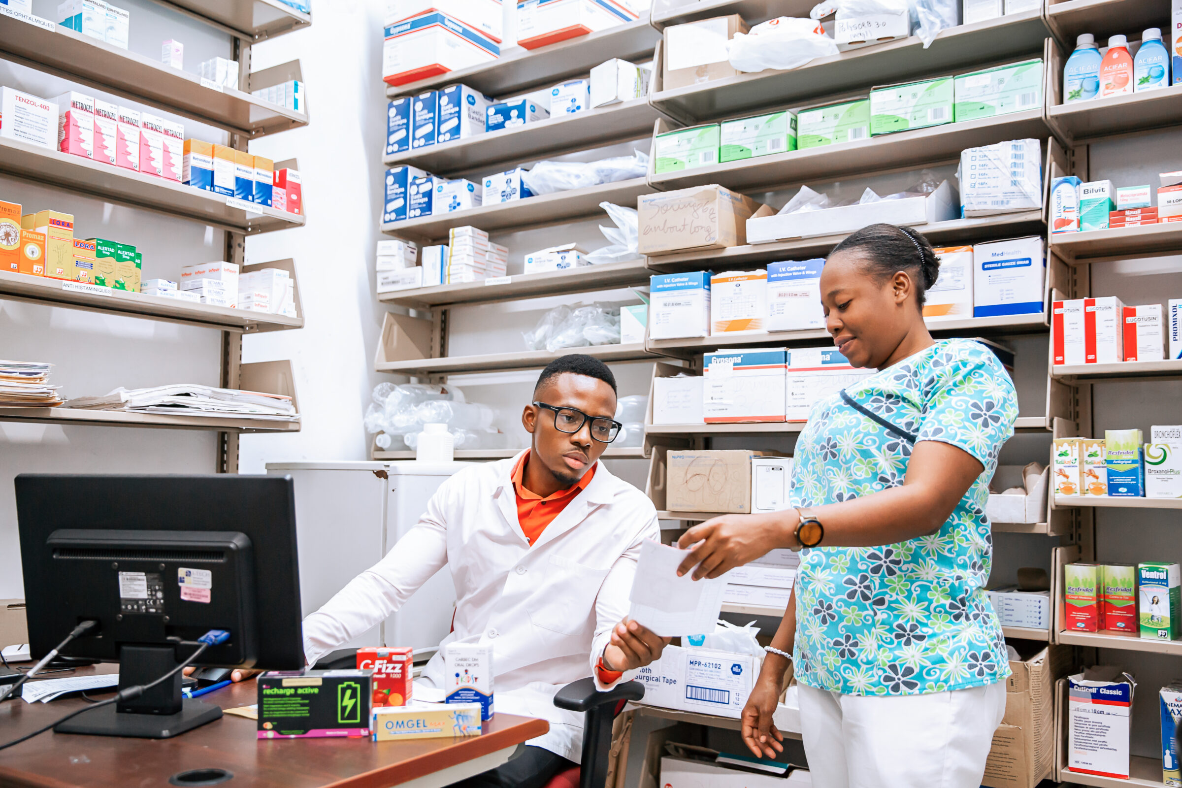 two doctors in a room with medications